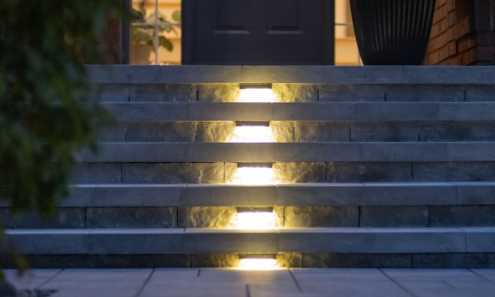 custom retaining wall with glass railings lighting